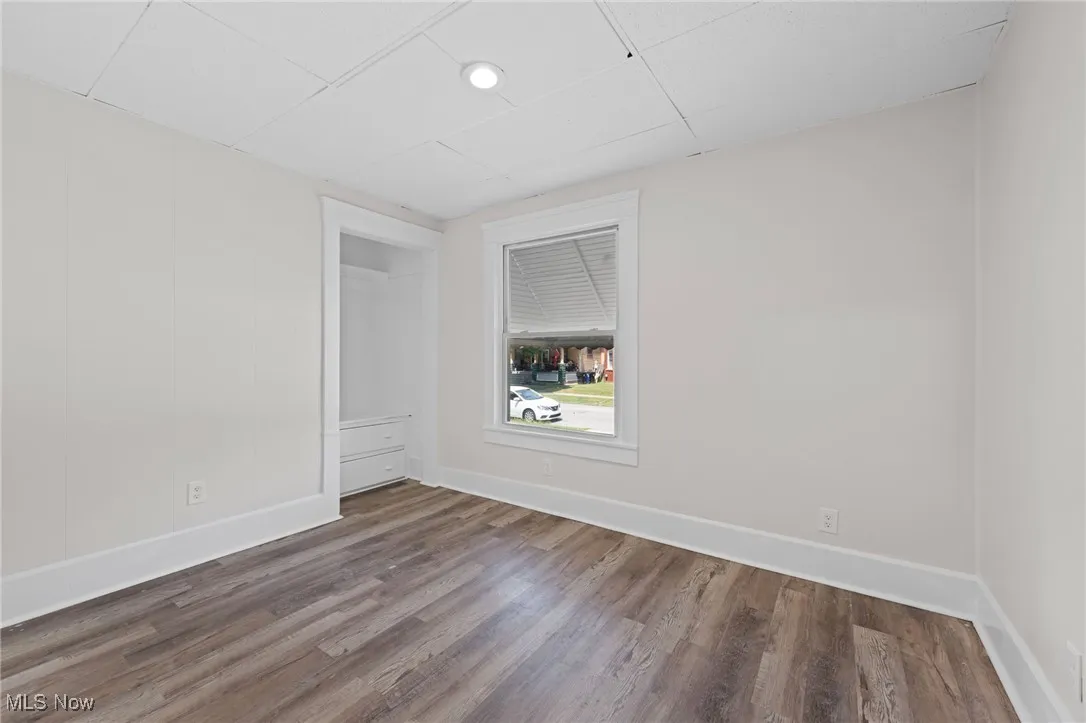 Unfurnished room with wood finished floors and recessed lighting