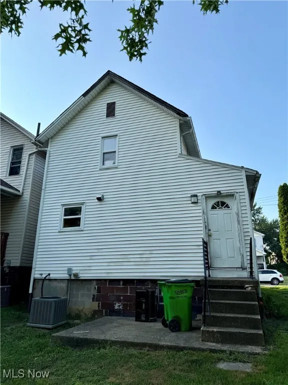 Rear view of property with entry steps