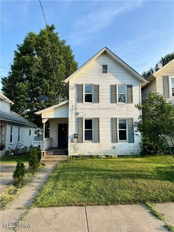 View of front of home featuring a porch and a front lawn