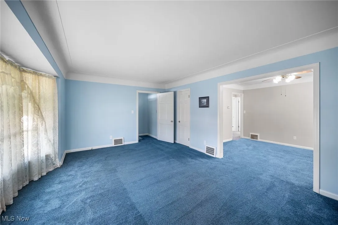 Living Room with carpet floors and crown molding
