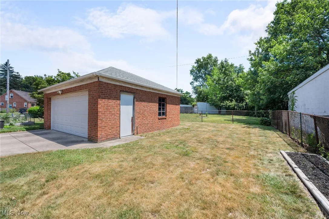 View of yard featuring concrete driveway and an attached garage