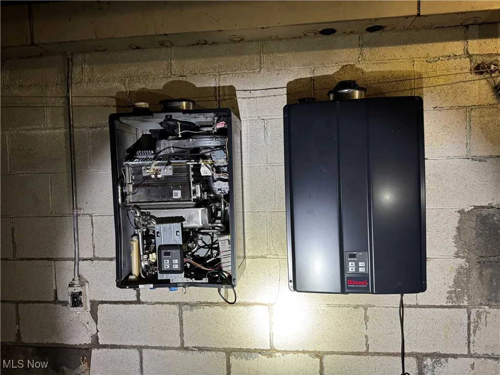 Utility room with electric panel and water heater