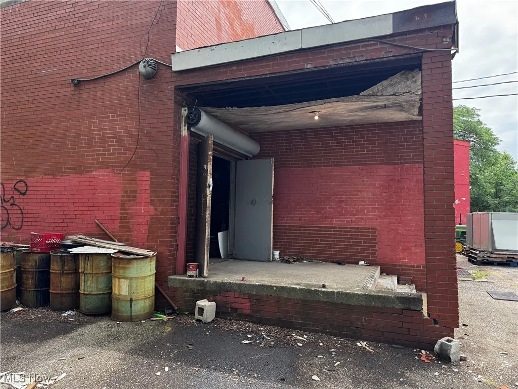 Entrance to property featuring brick siding