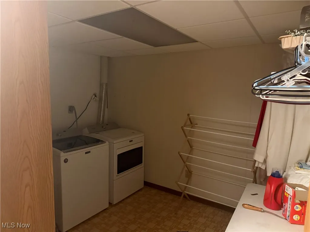 Washroom featuring washer and dryer and tile patterned floors