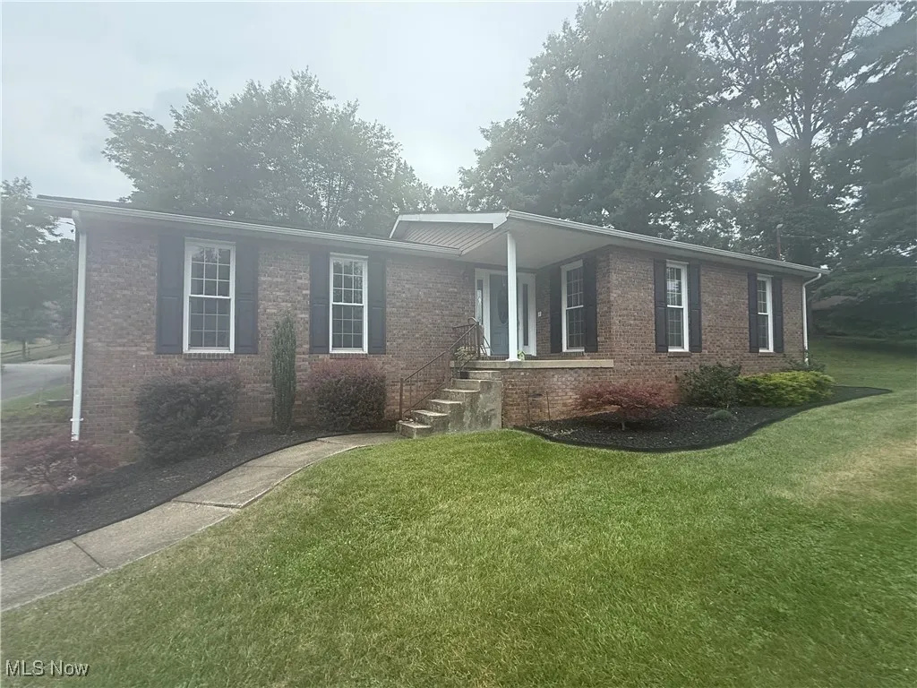 Ranch-style house with brick siding and a front yard