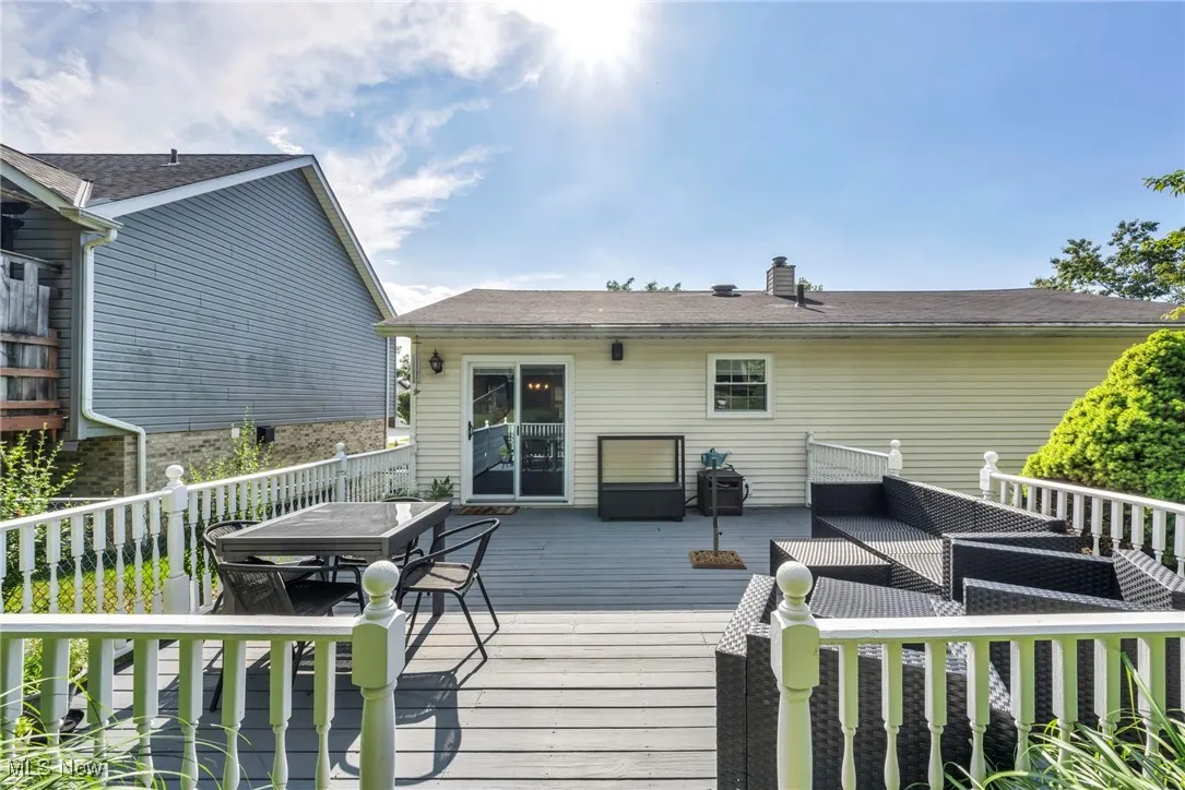 Wooden terrace featuring outdoor dining area, outdoor lounge area, and grilling area