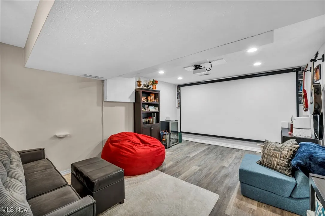 Home theater featuring wood finished floors and recessed lighting
