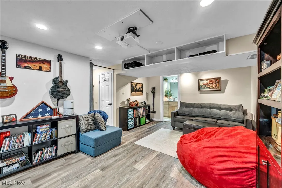 Living room featuring wood finished floors and recessed lighting