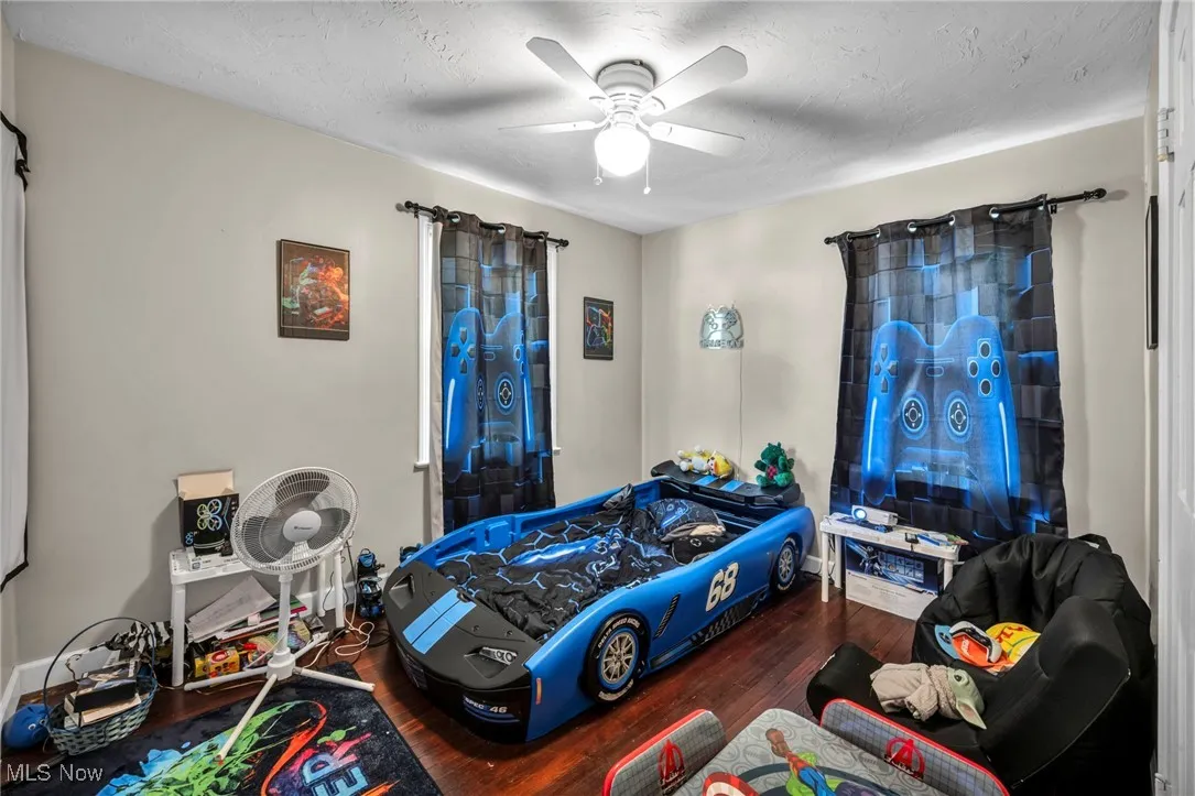 Bedroom featuring wood finished floors and a ceiling fan