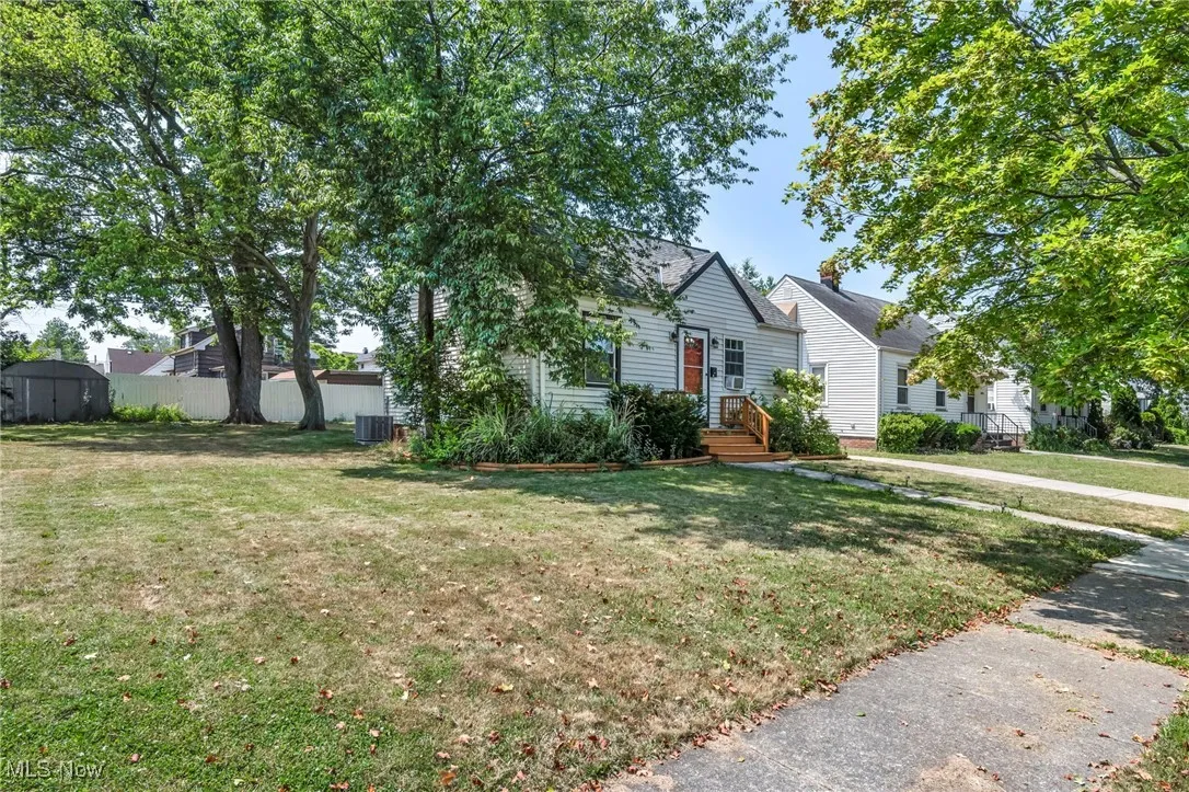 View of front facade with a storage shed and a front yard