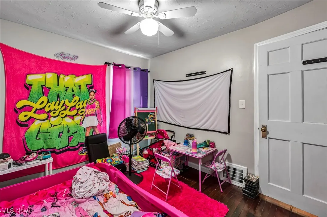 Bedroom with wood-type flooring and ceiling fan