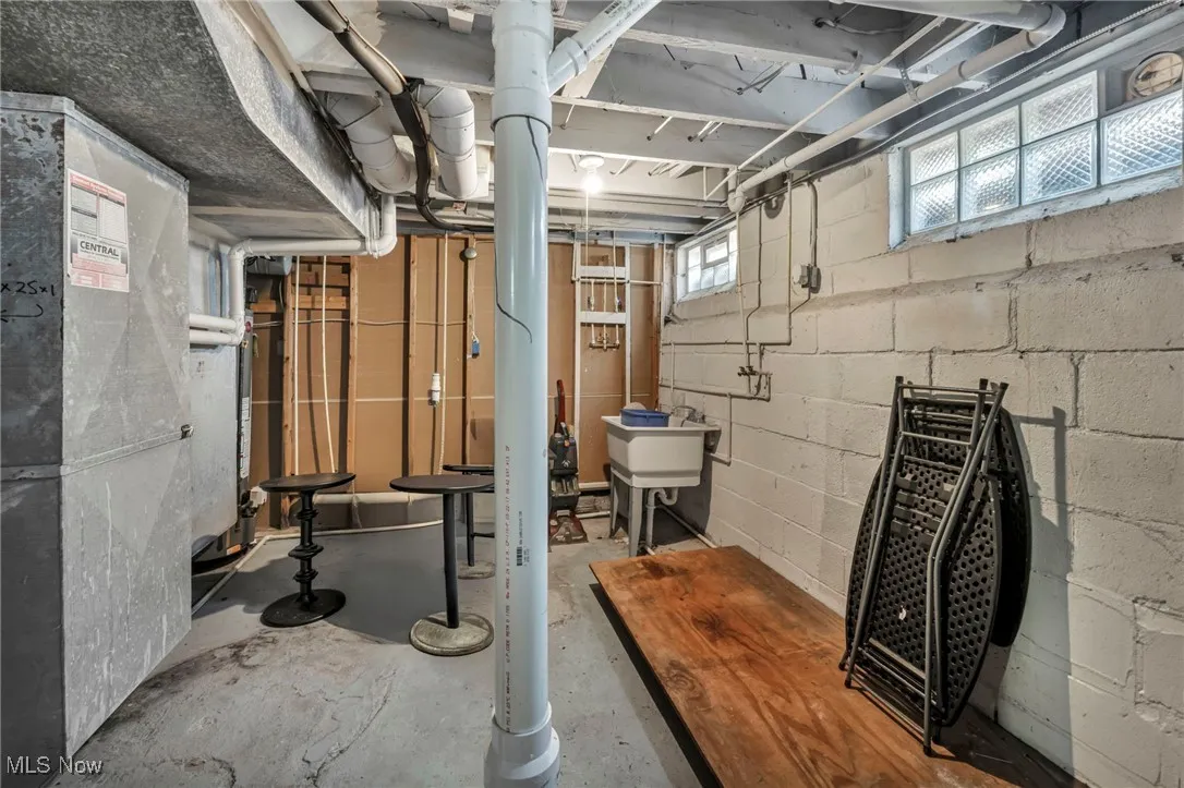 Basement with heating unit and concrete block wall