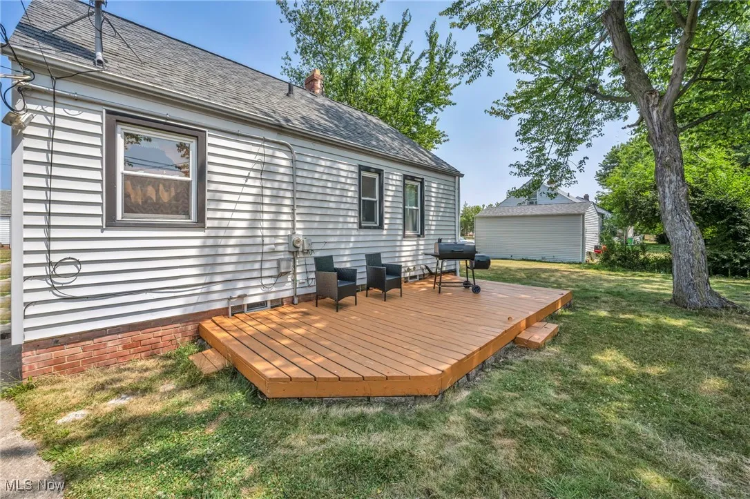 Deck with a grill and a yard