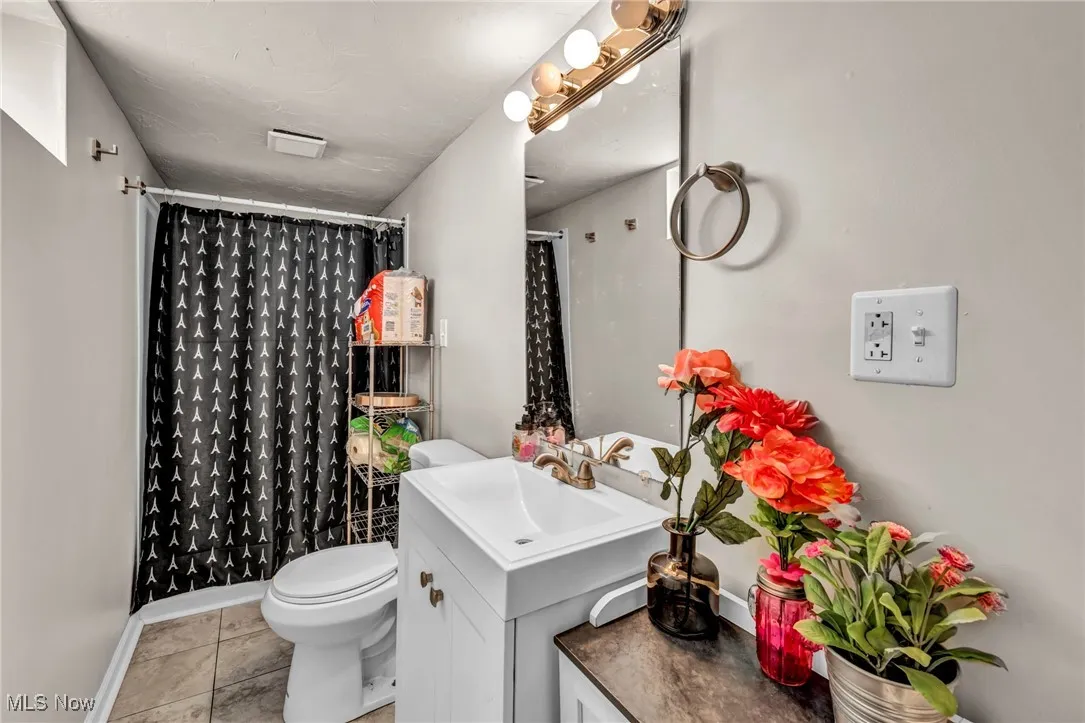 Full bath with vanity and a shower with curtain