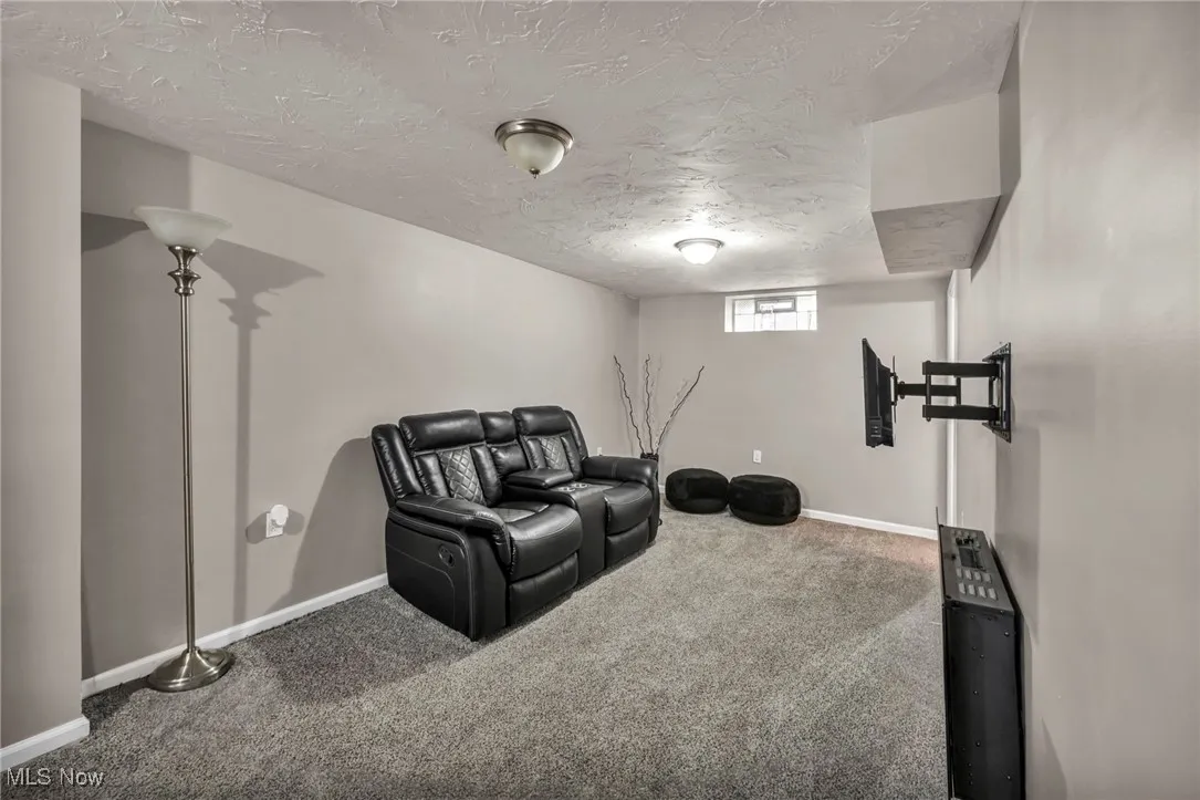 Exercise area featuring carpet and a textured ceiling