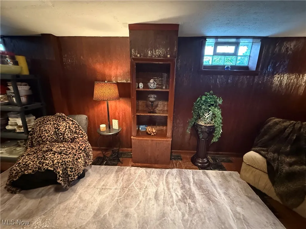 Living area featuring wooden walls