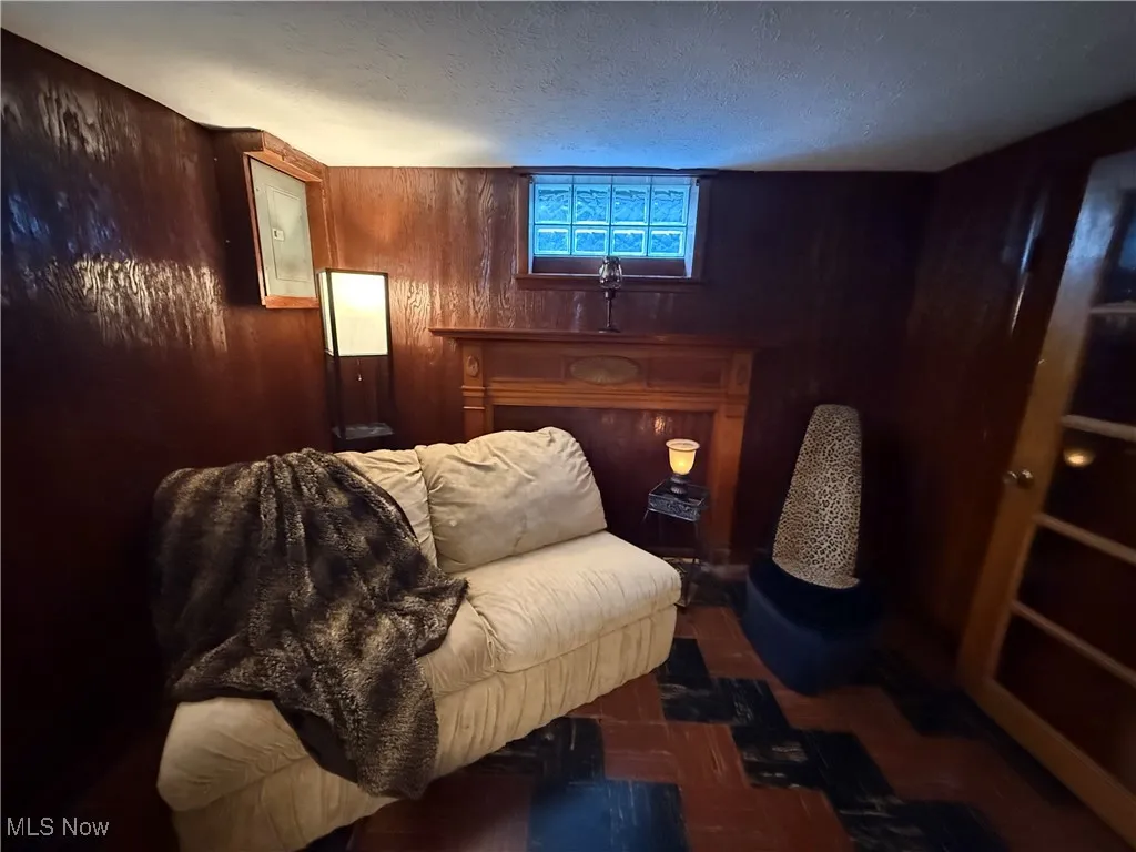 Bedroom featuring wood walls and a textured ceiling
