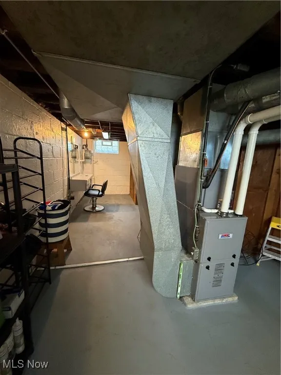 Basement with heating unit and a sink