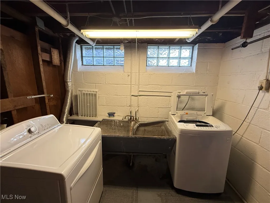 Laundry area featuring washing machine and dryer and plenty of natural light