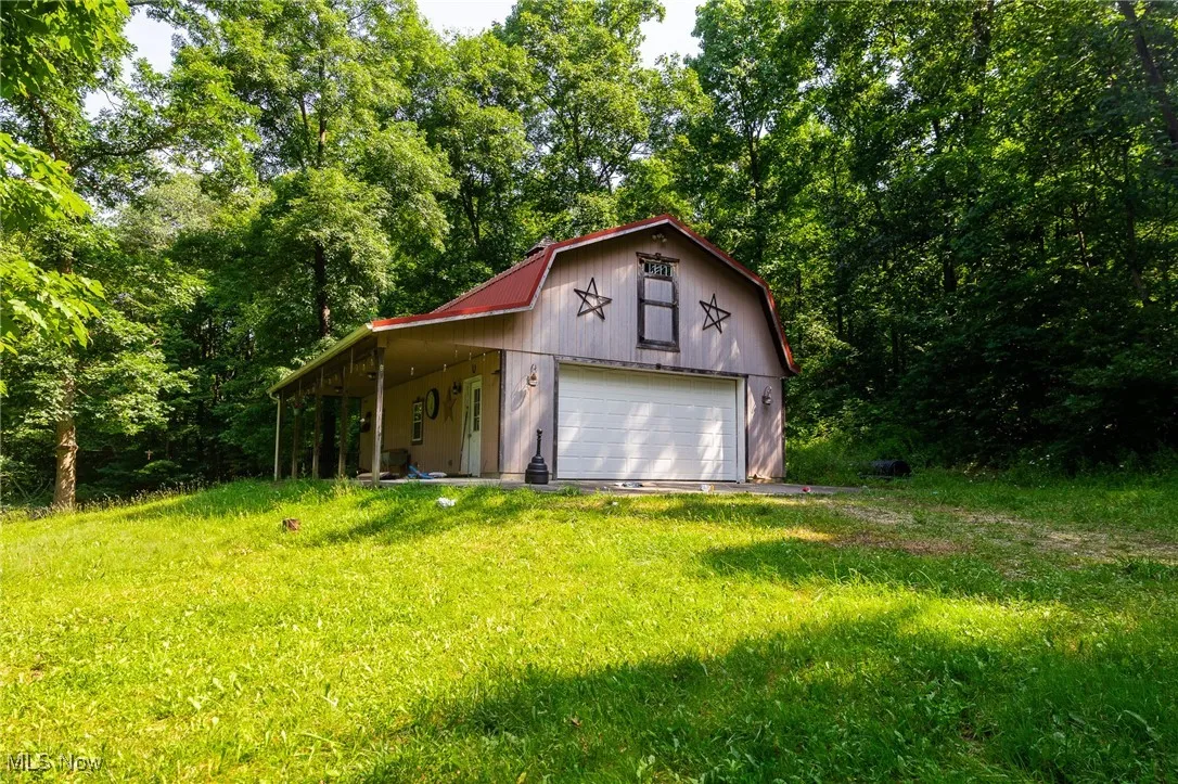 Garage featuring a detached garage and driveway