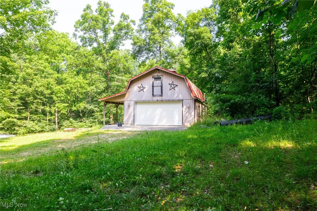 Garage featuring a garage and driveway