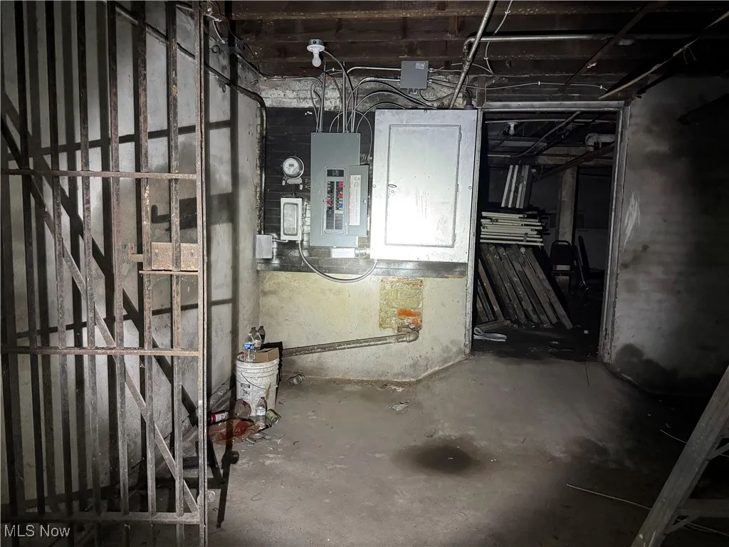 Unfinished basement with electric panel