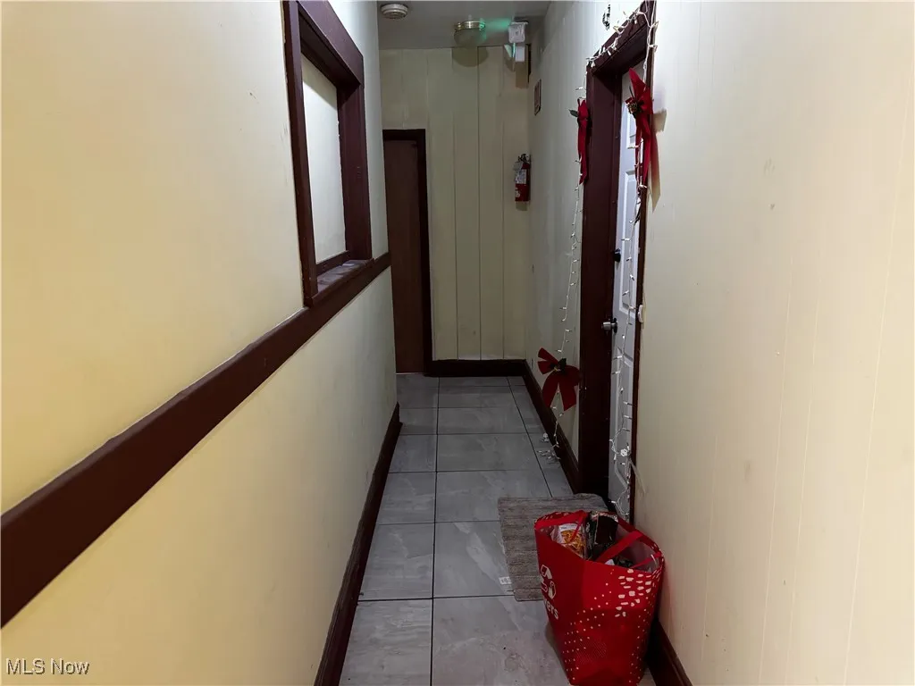 Hallway featuring tile patterned floors
