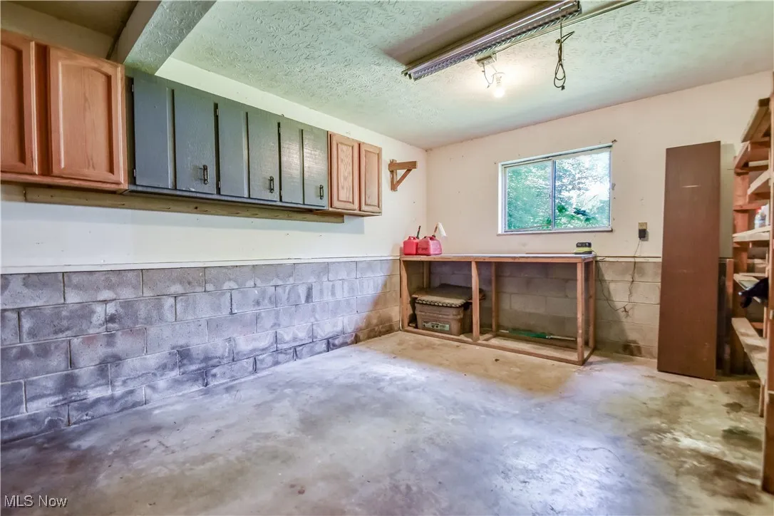 Garage featuring concrete block wall