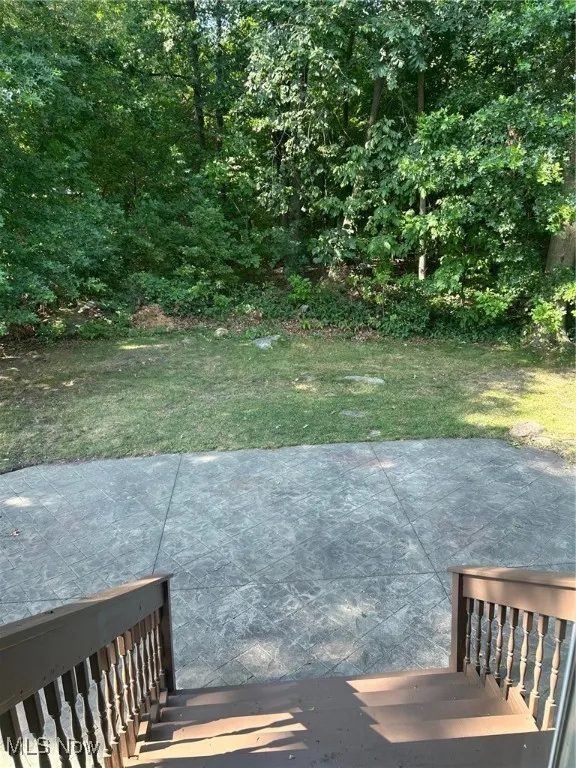 Wooded backyard and stamped patio