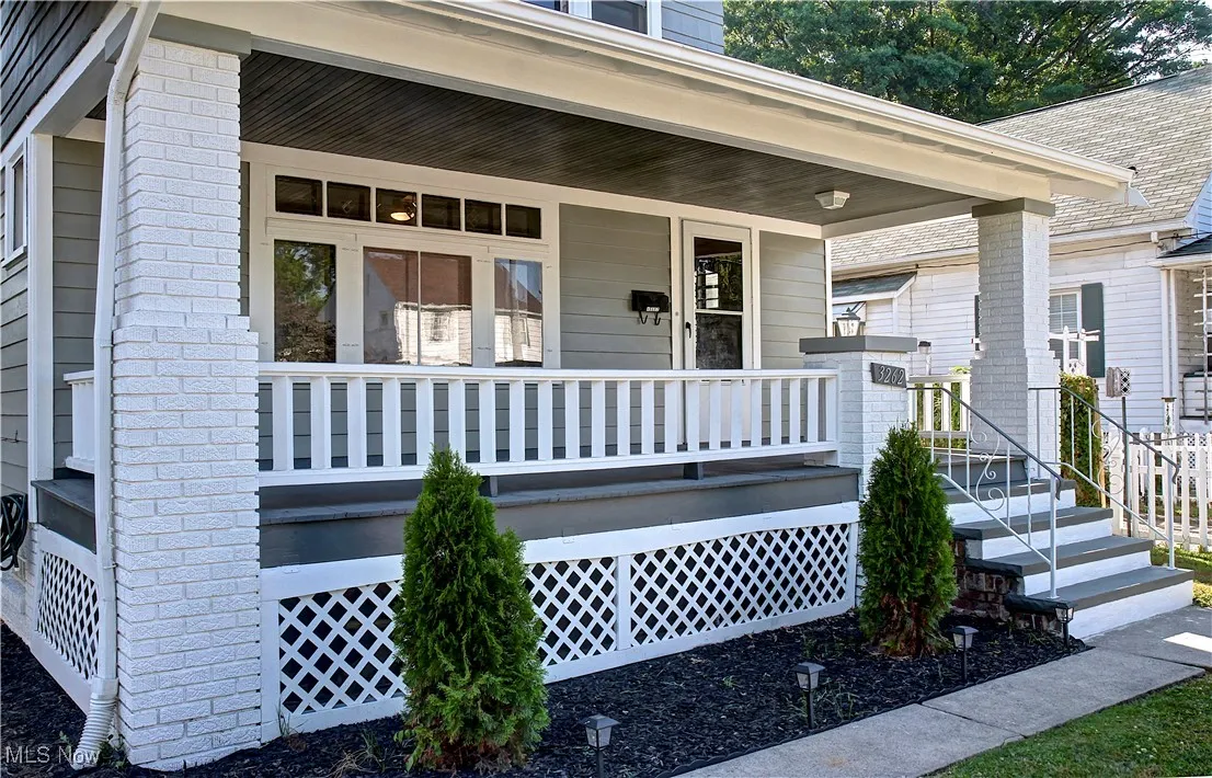 View of exterior entry featuring covered porch