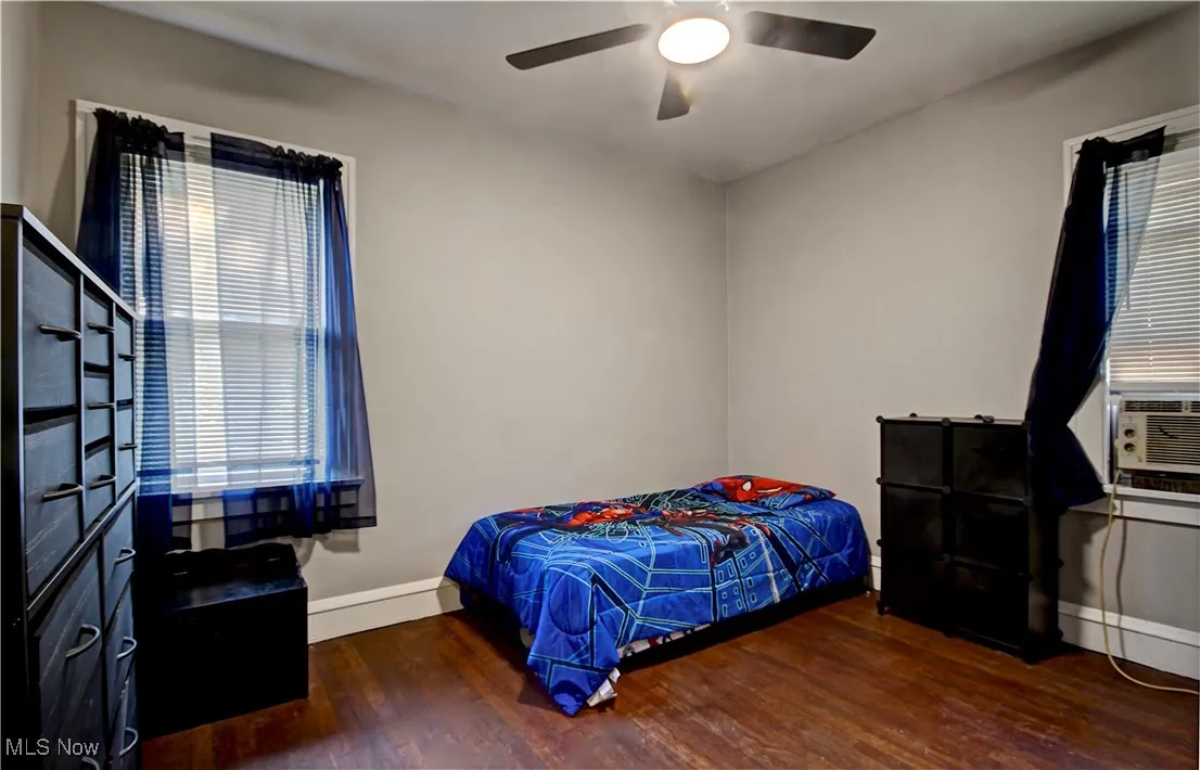 Bedroom with wood finished floors and a ceiling fan