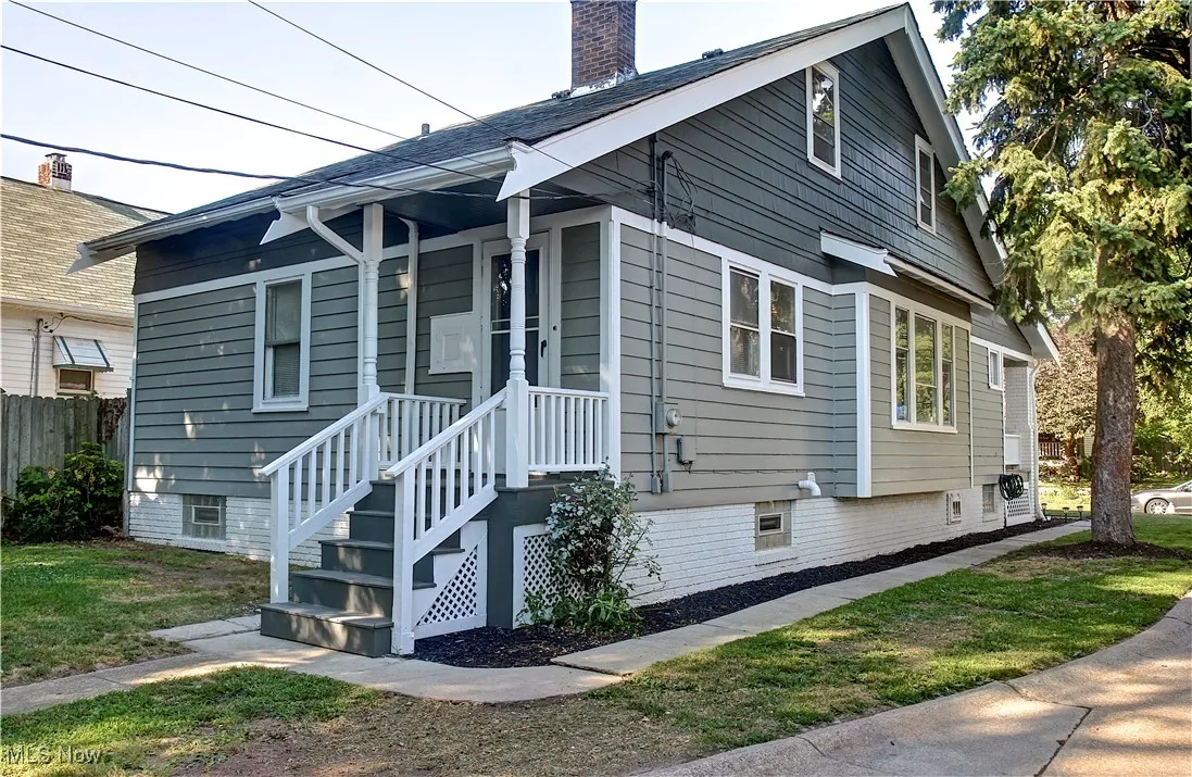 View of side of home featuring a chimney
