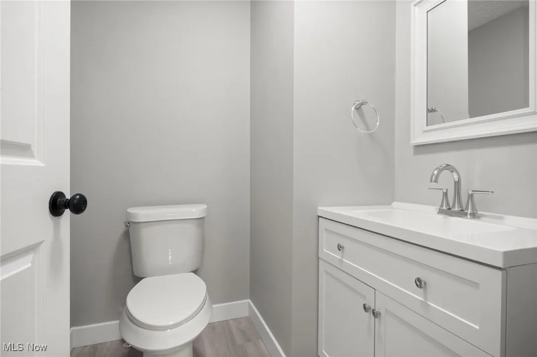 Bathroom with vanity and wood finished floors