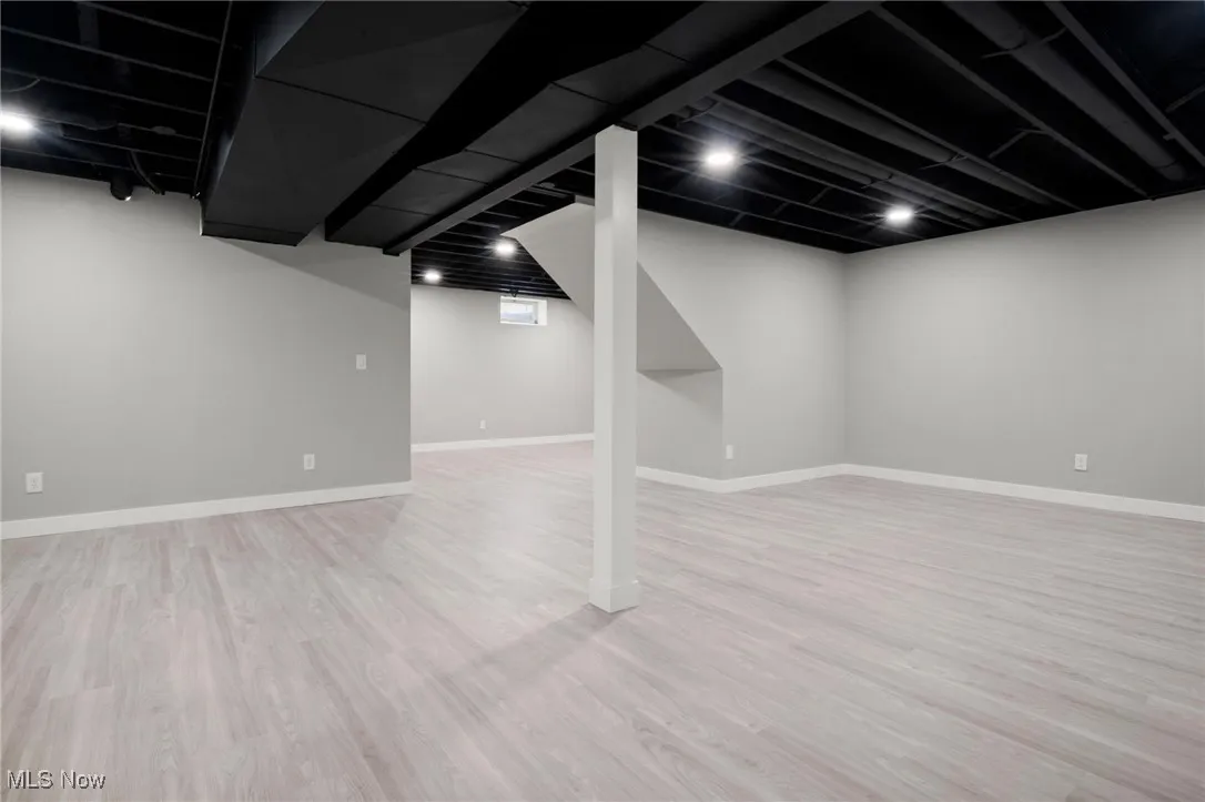 Finished below grade area with wood finished floors and baseboards
