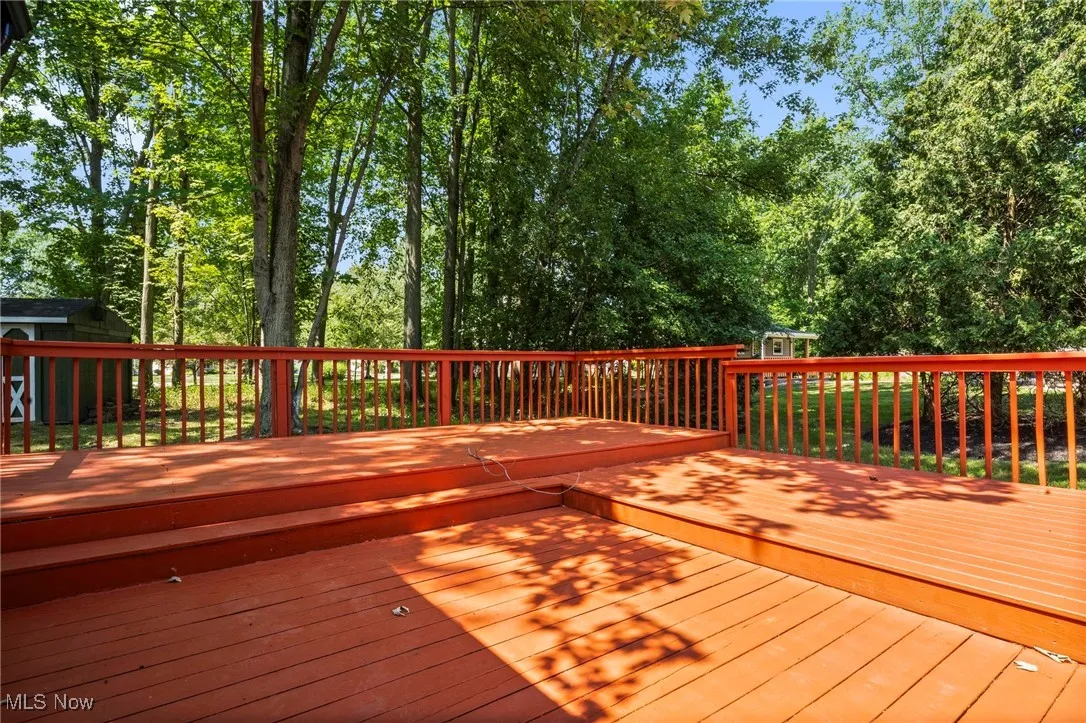 Deck featuring view of wooded area