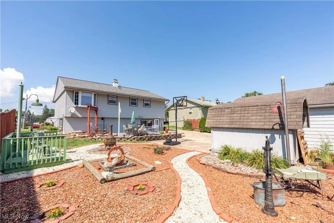 Back of house featuring a patio and a storage shed