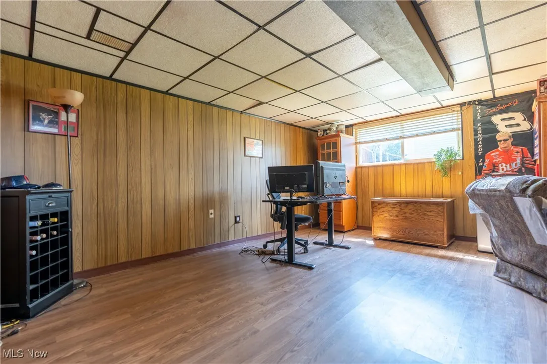 Office area with wood finished floors and wooden walls