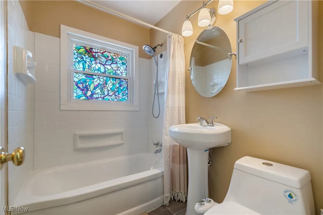 Full bath with shower / bath combo and toilet