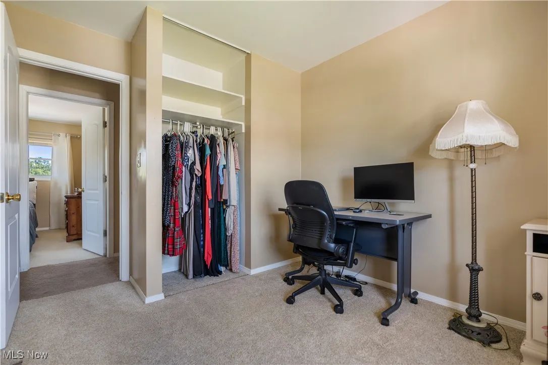Home office with carpet flooring and baseboards