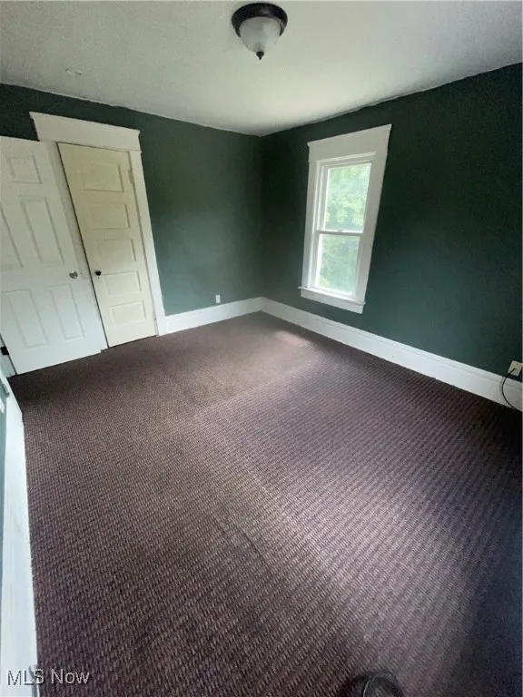 Bedroom in atticwith carpet floors and lofted ceiling