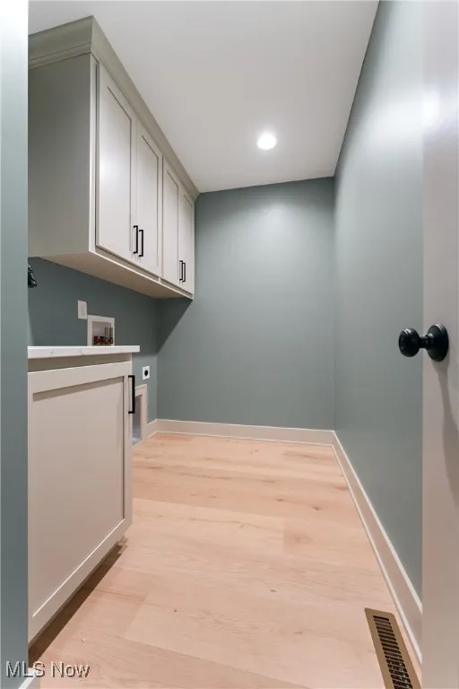 Washroom featuring light wood-type flooring, electric dryer hookup, and washer hookup