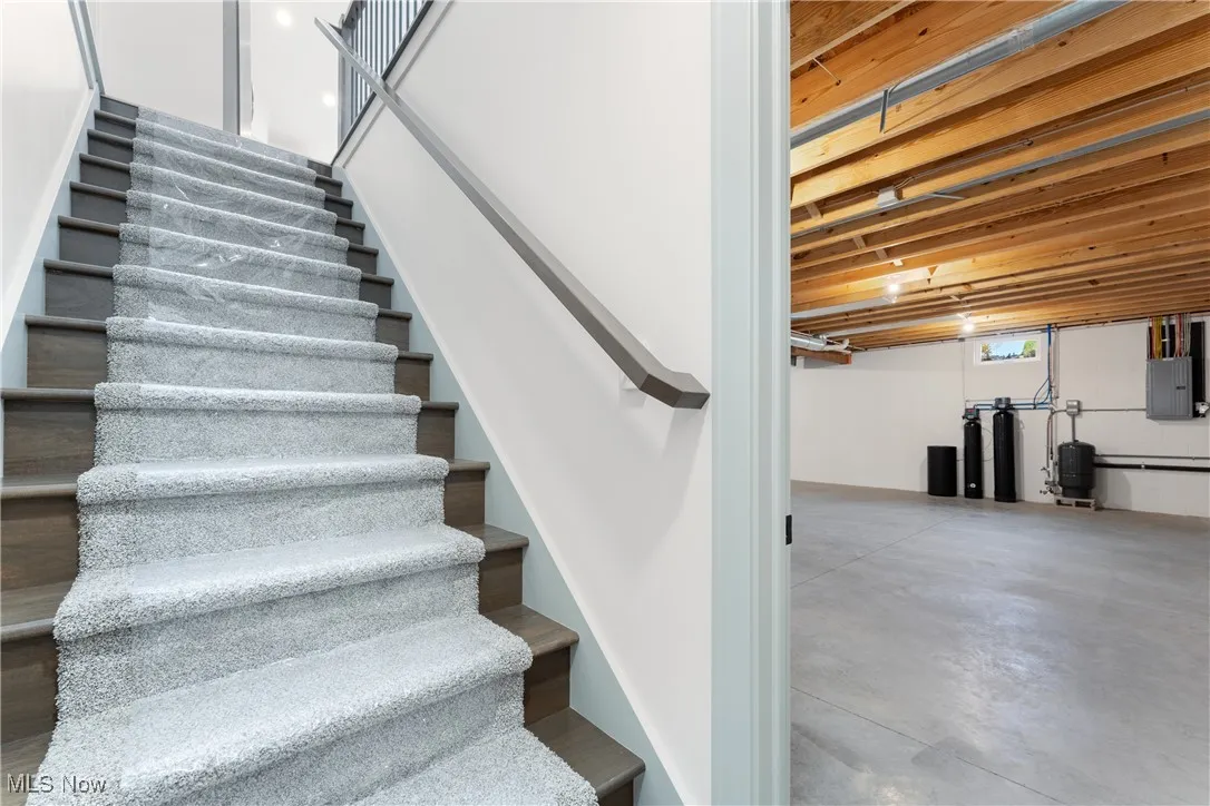 Staircase with concrete flooring and electric panel