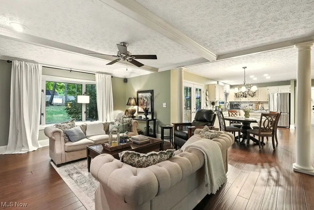 Family Room with Bamboo Flooring, Fireplace with Mantle, Built-in Beverage Fridge, and Extra Wide Baseboards