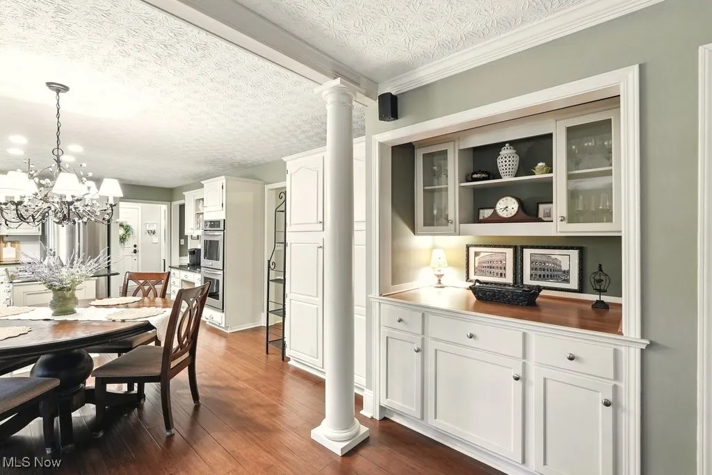 Eat-in Kitchen with Granite Counters, Subway Backsplash, Gas Cooktop, Double Oven, Updated Kitchen Cabinets, Island with a Stove Top, and Extra Wide Baseboards