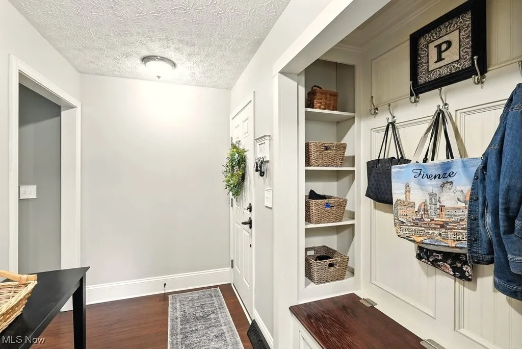 Mud Room with Bamboo Flooring and Idividual Benches with Shelves