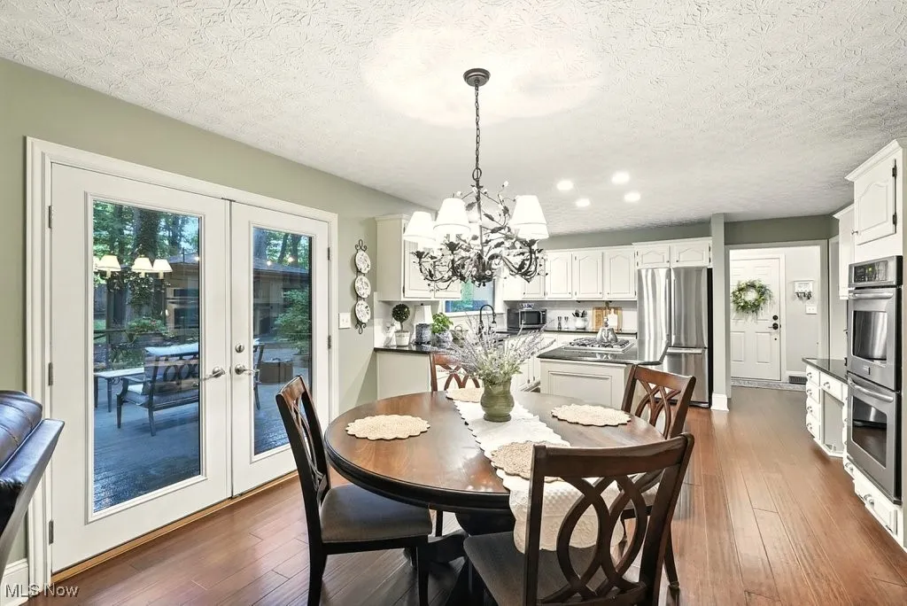 Eat-in Kitchen with Granite Counters, Subway Backsplash, Gas Cooktop, Double Oven, Updated Kitchen Cabinets, Island with a Stove Top, and Extra Wide Baseboards