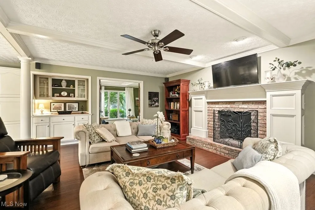 Family Room with Bamboo Flooring, Fireplace with Mantle, Built-in Beverage Fridge, and Extra Wide Baseboards