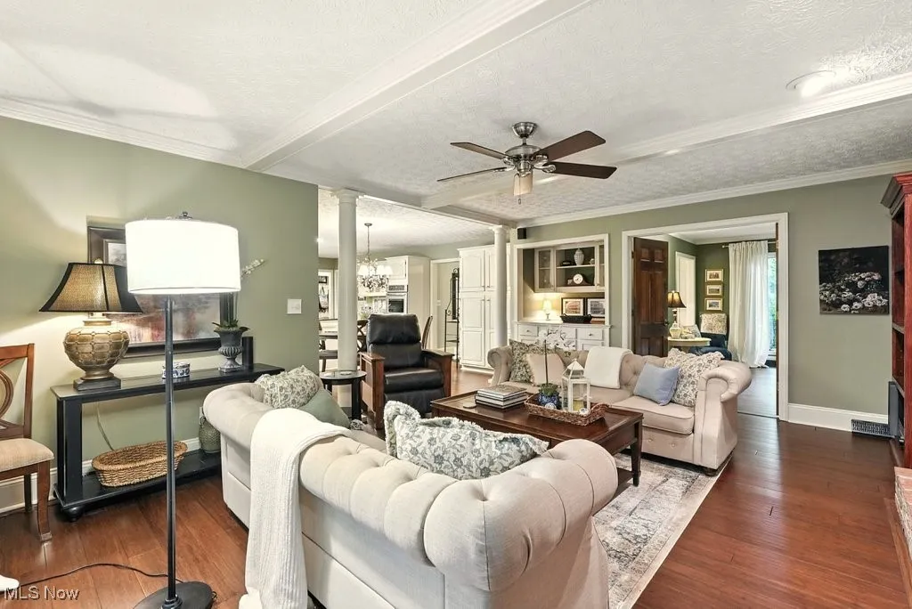 Family Room with Bamboo Flooring, Fireplace with Mantle, Built-in Beverage Fridge, and Extra Wide Baseboards