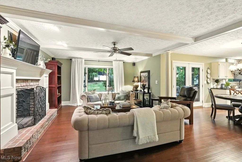 Family Room with Bamboo Flooring, Fireplace with Mantle, Built-in Beverage Fridge, and Extra Wide Baseboards
