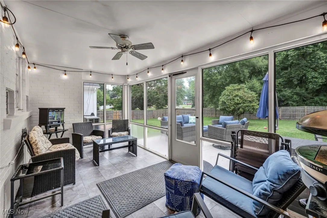 Sunroom / solarium featuring an outdoor living space, rail lighting, and a ceiling fan